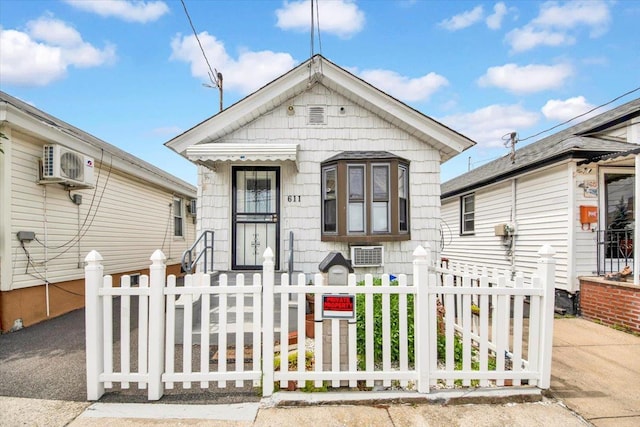 611 Clarence Ave, Bronx, NY 10465 - shotgun-style home with a fenced front yard and ac unit