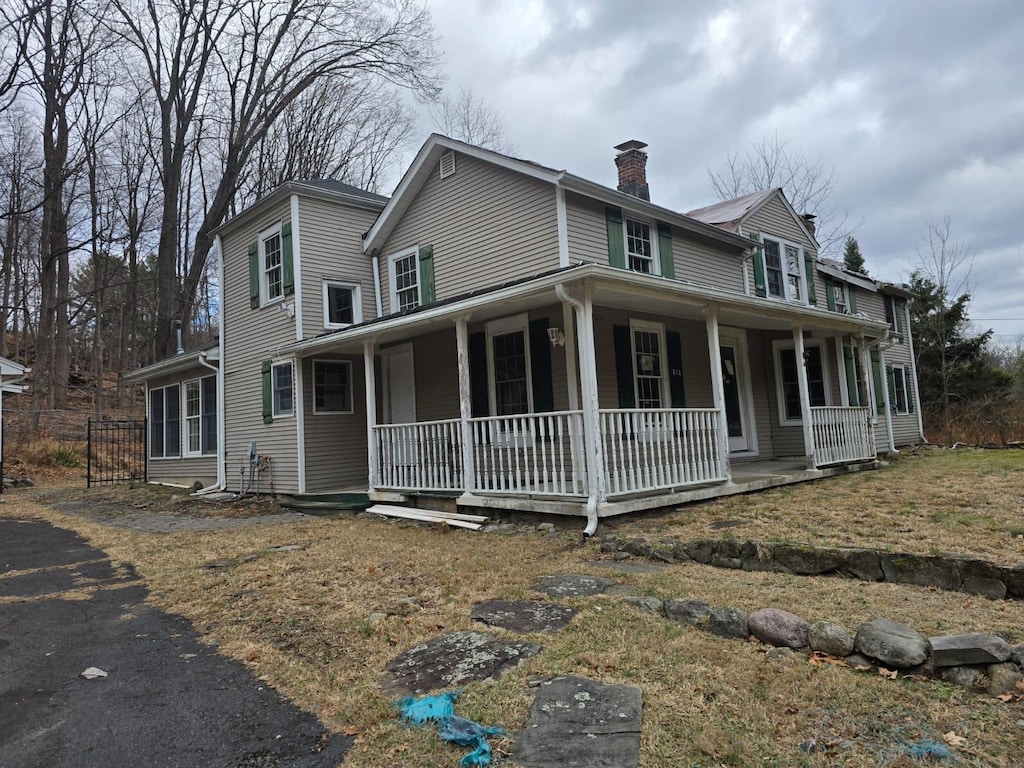 101 Lime Kiln Rd, Suffern, NY 10901 - farmhouse-style home featuring a chimney and a porch