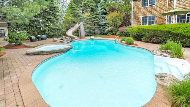 1260 Water Ter, Southold, NY 11971 - outdoor pool with a water slide, an in-ground hot tub, and a patio