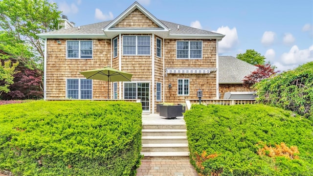 1260 Water Ter, Southold, NY 11971 - rear view of house with a chimney, a deck, and a shingled roof