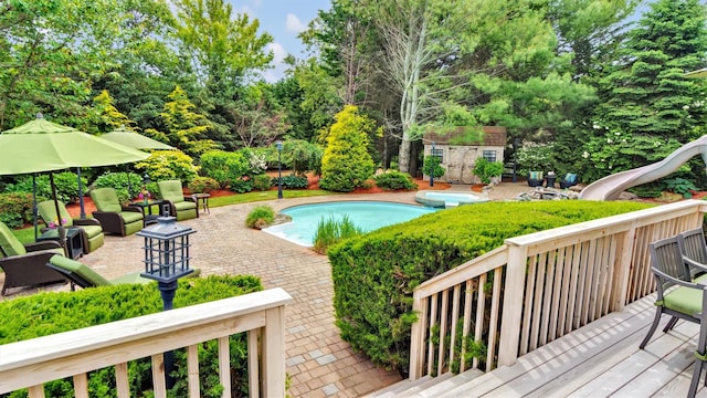 1260 Water Ter, Southold, NY 11971 - view of swimming pool with a deck, a water slide, a patio, and view of scattered trees