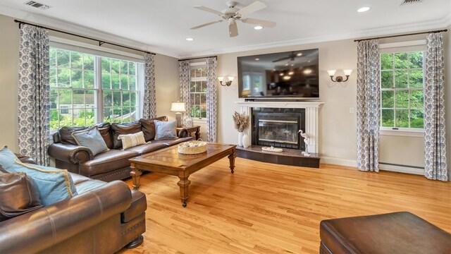 1260 Water Ter, Southold, NY 11971 - living area featuring a baseboard heating unit, a ceiling fan, light wood finished floors, healthy amount of natural light, and recessed lighting