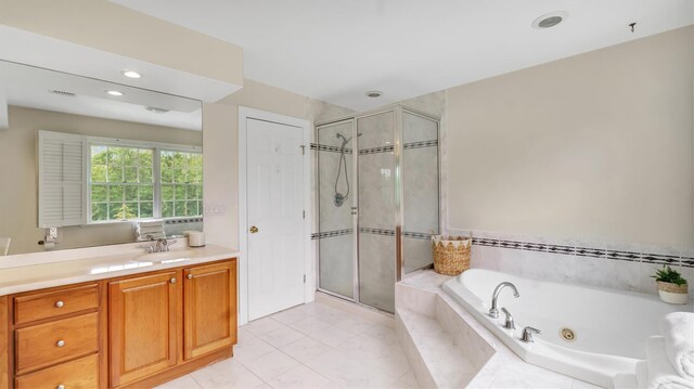 1260 Water Ter, Southold, NY 11971 - bathroom with vanity, a stall shower, a jetted tub, and recessed lighting