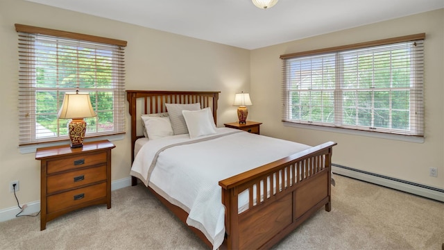 1260 Water Ter, Southold, NY 11971 - bedroom with light carpet, multiple windows, a baseboard heating unit, and baseboards