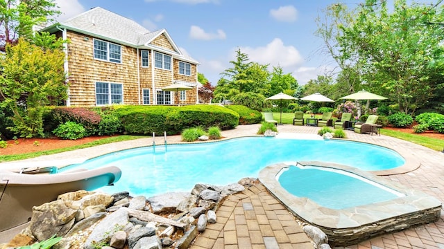 1260 Water Ter, Southold, NY 11971 - view of pool featuring a water slide, a patio, and a pool with connected hot tub