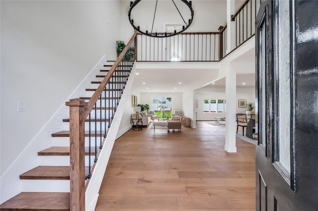 205 Blueberry Ln, Hicksville, NY 11801 - entryway with stairs, wood finished floors, a towering ceiling, and a chandelier