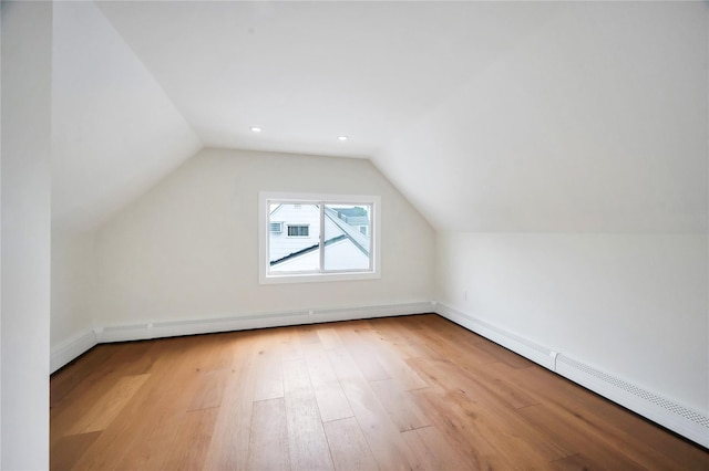 205 Blueberry Ln, Hicksville, NY 11801 - bonus room featuring a baseboard radiator, wood finished floors, vaulted ceiling, baseboards, and recessed lighting