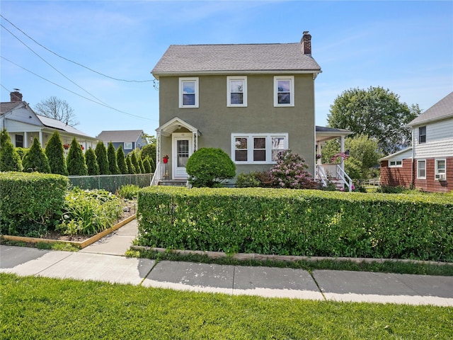80 Woodland St, Mount Kisco, NY 10549 - colonial inspired home with a chimney, stucco siding, and covered porch