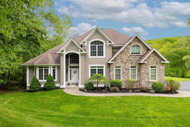 66 Carol Ln, Poughquag, NY 12570 - view of front of home with stucco siding, stone siding, a front yard, and a shingled roof