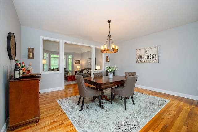 66 Carol Ln, Poughquag, NY 12570 - dining area with a chandelier, light wood-style flooring, and baseboards