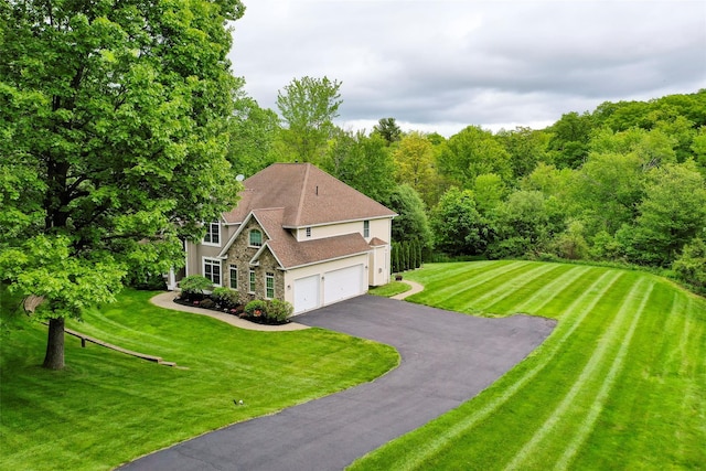 66 Carol Ln, Poughquag, NY 12570 - view of front facade featuring stucco siding, driveway, stone siding, a view of trees, and a front yard