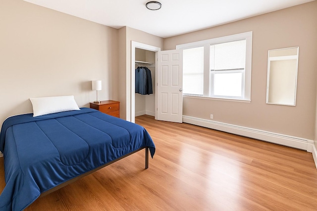 45 Cragmere Rd, Airmont, NY 10901 - bedroom with a baseboard radiator, wood finished floors, a closet, and baseboards
