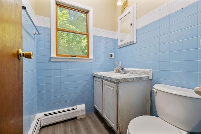 12 Gillis Ave, Nyack, NY 10960 - bathroom featuring tile walls, vanity, wood finished floors, and a baseboard heating unit
