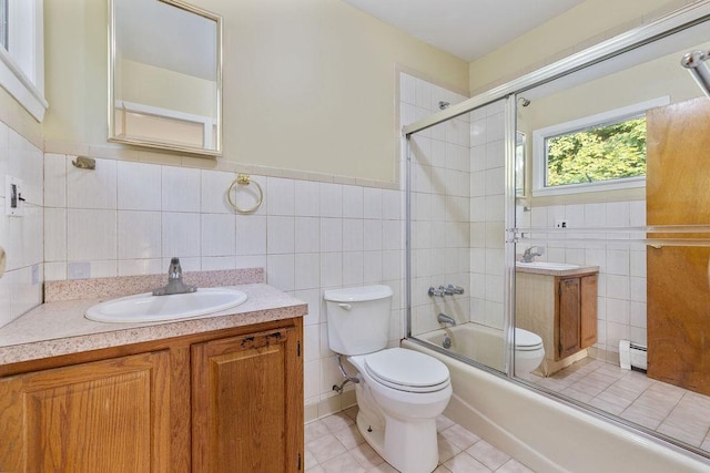12 Gillis Ave, Nyack, NY 10960 - full bathroom with tile walls, vanity, a baseboard heating unit, enclosed tub / shower combo, and tile patterned floors
