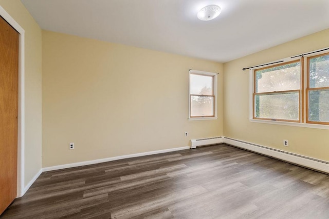 12 Gillis Ave, Nyack, NY 10960 - empty room with dark wood finished floors, healthy amount of natural light, and a baseboard heating unit