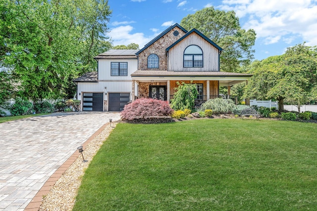 8 Hamilton Pl, Lake Grove, NY 11755 - view of front of house featuring covered porch, solar panels, decorative driveway, and a garage