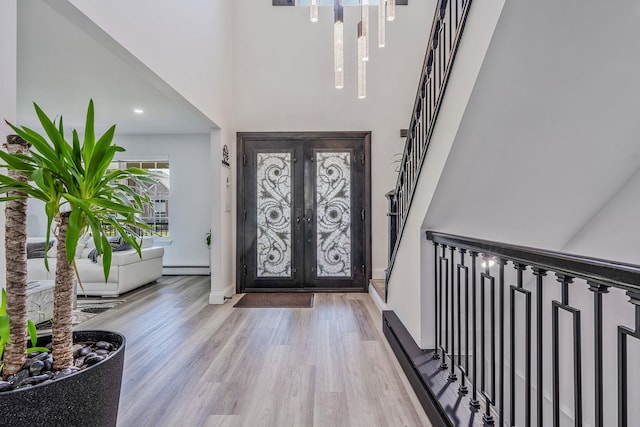 8 Hamilton Pl, Lake Grove, NY 11755 - entryway with french doors, wood finished floors, stairway, a high ceiling, and baseboards