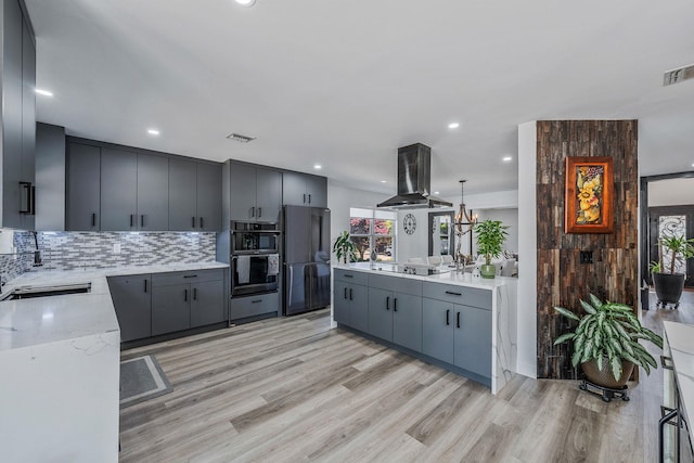 8 Hamilton Pl, Lake Grove, NY 11755 - kitchen with island exhaust hood, double oven, tasteful backsplash, freestanding refrigerator, and light wood-style flooring