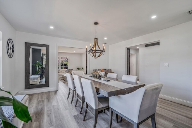 8 Hamilton Pl, Lake Grove, NY 11755 - dining space featuring a chandelier, light wood-type flooring, recessed lighting, and baseboards