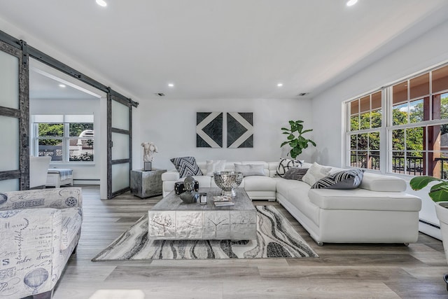 8 Hamilton Pl, Lake Grove, NY 11755 - living room with a barn door, plenty of natural light, recessed lighting, wood finished floors, and baseboard heating