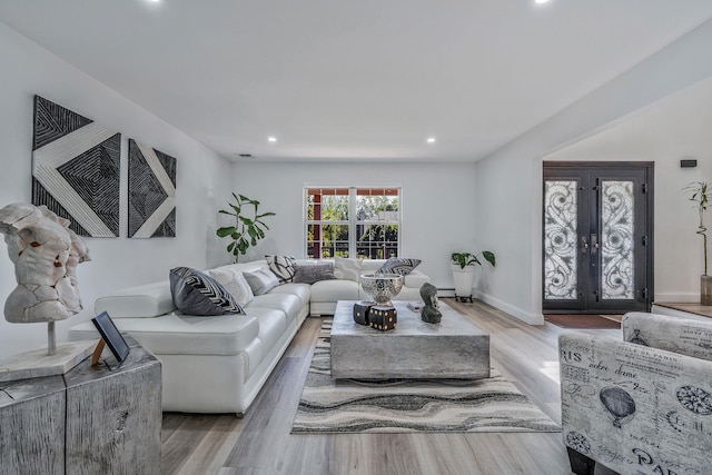 8 Hamilton Pl, Lake Grove, NY 11755 - living room featuring light wood finished floors, recessed lighting, baseboards, and french doors