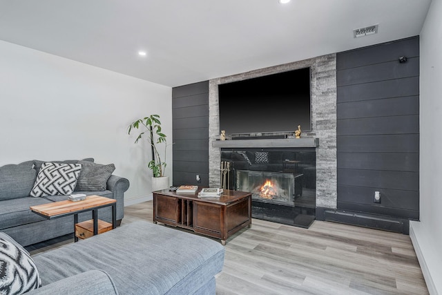 8 Hamilton Pl, Lake Grove, NY 11755 - living area featuring a large fireplace, baseboards, wood finished floors, and recessed lighting