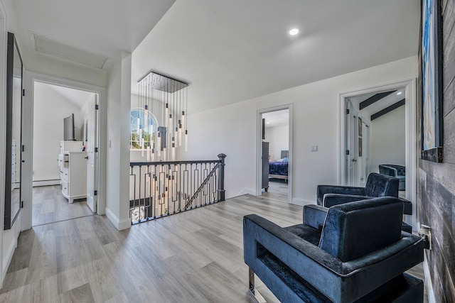 8 Hamilton Pl, Lake Grove, NY 11755 - corridor with an upstairs landing, light wood-style floors, attic access, a baseboard heating unit, and baseboards