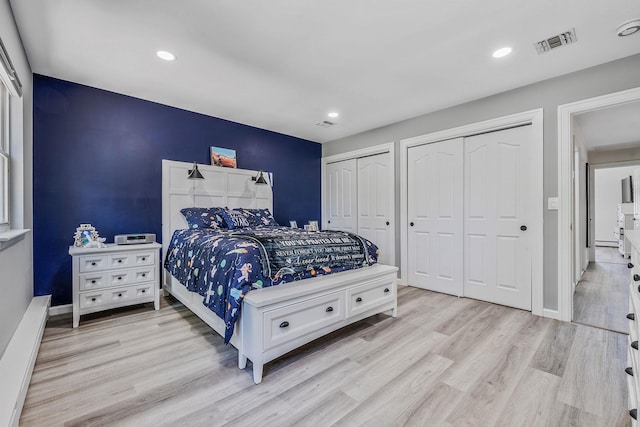 8 Hamilton Pl, Lake Grove, NY 11755 - bedroom with two closets, light wood-style flooring, recessed lighting, baseboard heating, and baseboards