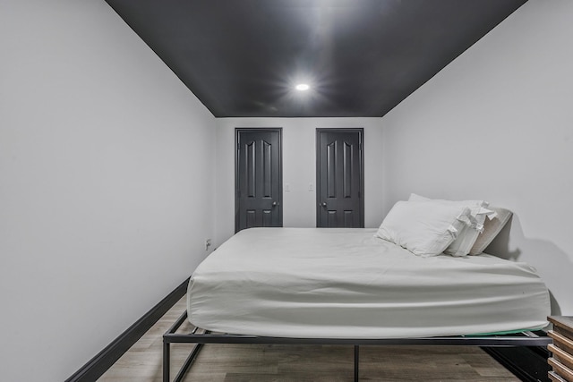 8 Hamilton Pl, Lake Grove, NY 11755 - bedroom with wood finished floors, baseboards, recessed lighting, and two closets