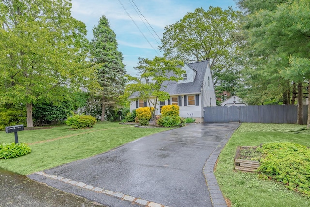 59 Burney Blvd, Mastic, NY 11950 - cape cod-style house featuring driveway and a gate