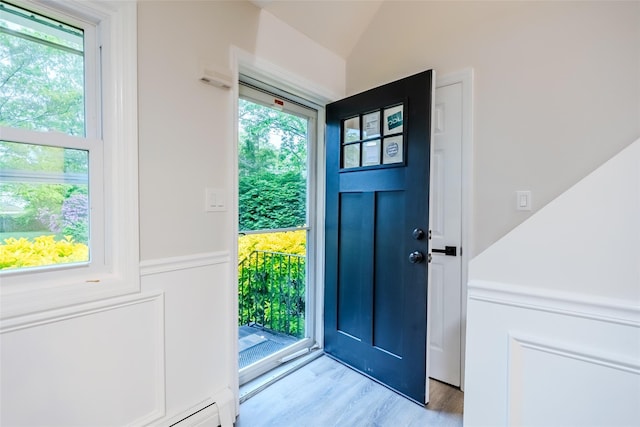 59 Burney Blvd, Mastic, NY 11950 - foyer with healthy amount of natural light, light wood-style flooring, lofted ceiling, and a baseboard radiator