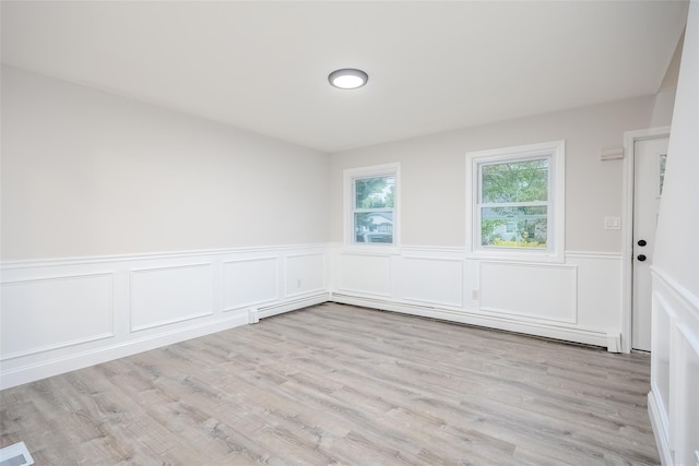 59 Burney Blvd, Mastic, NY 11950 - unfurnished room with wainscoting, wood finished floors, and a decorative wall