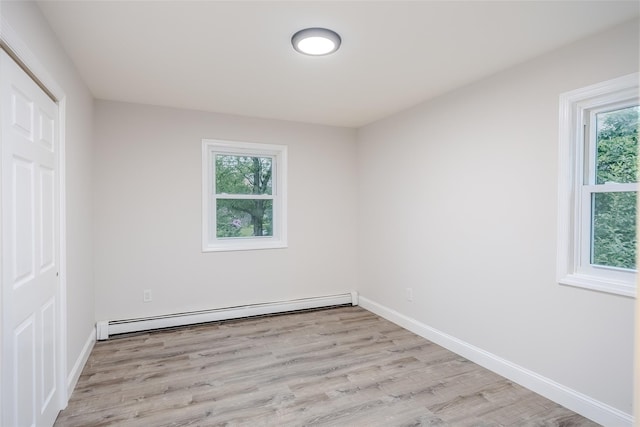 59 Burney Blvd, Mastic, NY 11950 - spare room featuring a baseboard radiator, wood finished floors, and baseboards