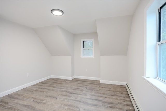59 Burney Blvd, Mastic, NY 11950 - bonus room featuring light wood-style flooring, a baseboard heating unit, baseboards, and lofted ceiling