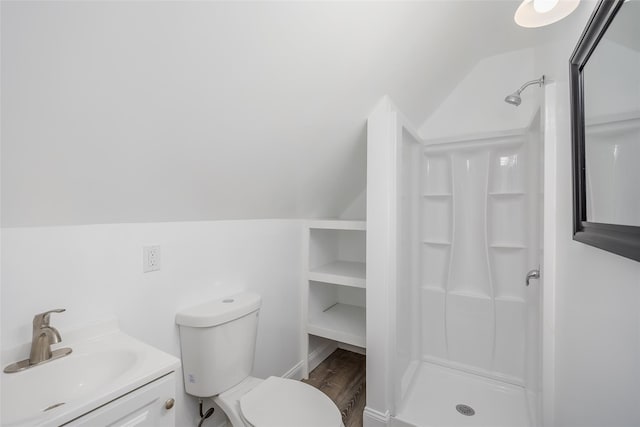 59 Burney Blvd, Mastic, NY 11950 - bathroom featuring vaulted ceiling, a stall shower, toilet, wood finished floors, and vanity