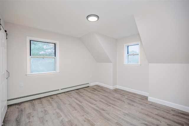 59 Burney Blvd, Mastic, NY 11950 - bonus room with a baseboard radiator, a barn door, wood finished floors, vaulted ceiling, and baseboards