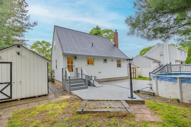 59 Burney Blvd, Mastic, NY 11950 - back of property featuring roof with shingles, a chimney, and a deck
