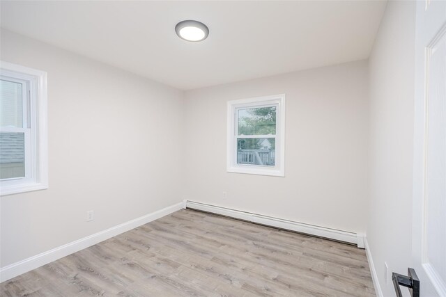 59 Burney Blvd, Mastic, NY 11950 - spare room with baseboard heating and wood finished floors