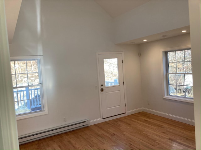 1626 Mogul Dr Unit 1626, Mohegan Lake, NY 10547 - entryway with a baseboard heating unit, wood finished floors, baseboards, and high vaulted ceiling