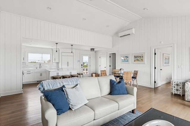 355 Dune Rd, Westhampton Beach, NY 11978 - living area featuring wood finished floors, a wall unit AC, and wood walls