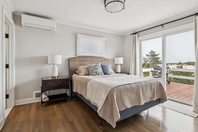 355 Dune Rd, Westhampton Beach, NY 11978 - bedroom featuring an AC wall unit, multiple windows, access to exterior, wood finished floors, and ornamental molding