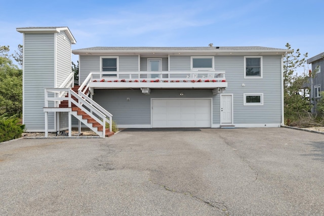 355 Dune Rd, Westhampton Beach, NY 11978 - view of front facade with stairs, an attached garage, and driveway