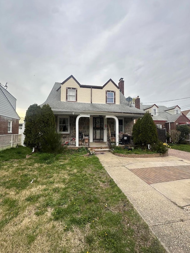 251 Grand Ave, Freeport, NY 11520 - view of front of house with a porch, a chimney, and stone siding
