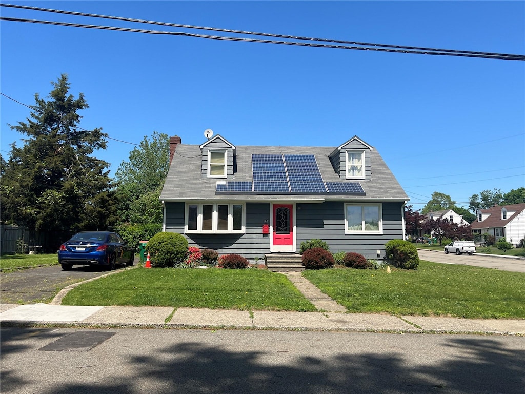 149 Wilkes St, Beacon, NY 12508 - cape cod home featuring solar panels, a front lawn, entry steps, and a chimney