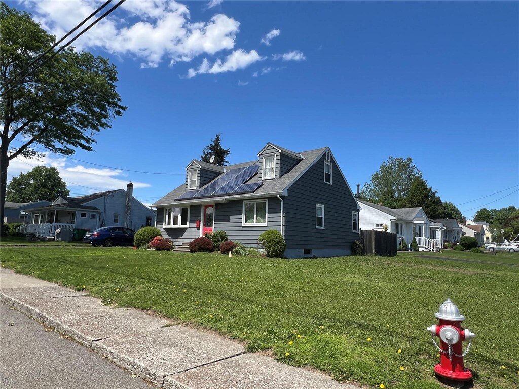149 Wilkes St, Beacon, NY 12508 - cape cod home featuring solar panels and a front lawn