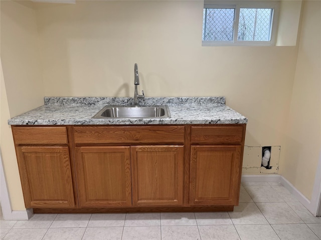 110 Terrace Ave, Elmont, NY 11003 - bar area featuring a sink, light tile patterned flooring, and baseboards