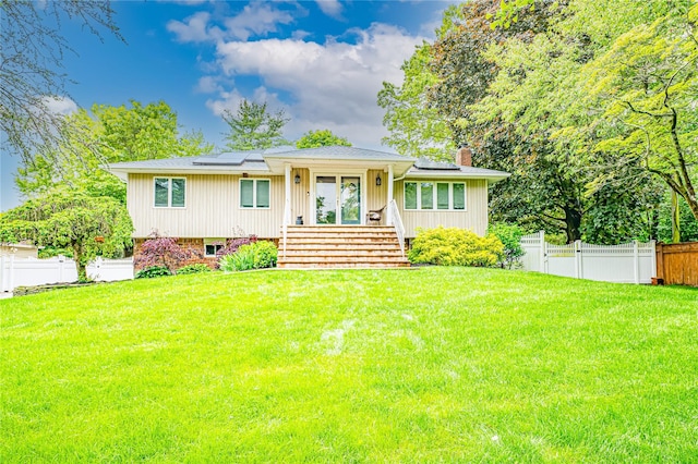 4 Greenvale Dr, East Northport, NY 11731 - view of front of house with roof mounted solar panels and a chimney
