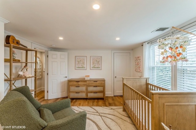 32 Henderson Ave, Port Washington, NY 11050 - living room featuring wood finished floors, recessed lighting, and ornamental molding