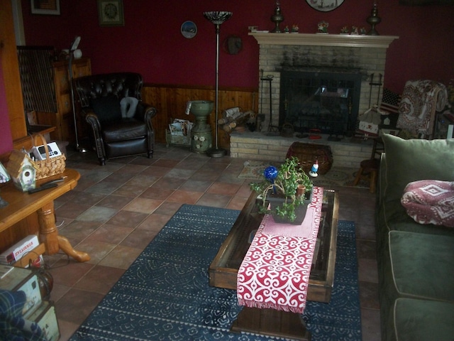 2713 Fox Rd, Baldwin, NY 11510 - tiled living area featuring a fireplace, wood walls, and a wainscoted wall