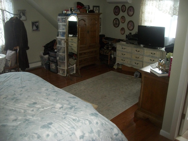 2713 Fox Rd, Baldwin, NY 11510 - bedroom with wood finished floors and baseboard heating